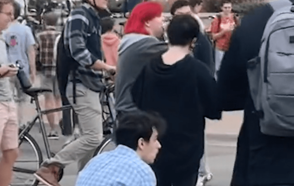 Leftist Rips Apart Bible And Eats It At Transgender Protest
